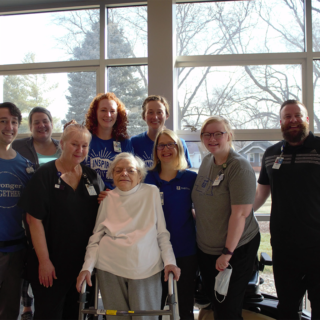 Tabitha Rehabilitation therapists and nurses that made a difference in Jeannette's journey of CARE gather for a photo on Jeannette's last day of inpatient rehabilitation at Tabitha's LifeQuest.